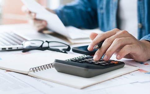 Hand using calculator